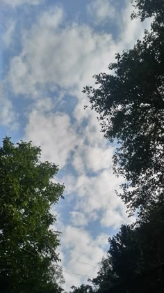 the sky is filled with clouds and trees