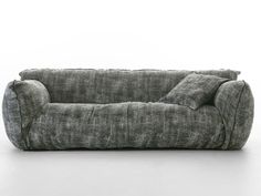 a gray couch sitting on top of a white floor