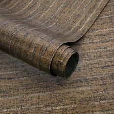 a close up view of a brown and beige wallpaper with lines on it's surface