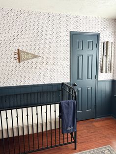 a baby crib in front of a blue door