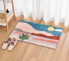 a pair of slippers sitting on top of a wooden floor next to a rug