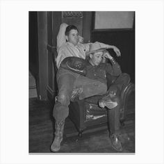 black and white photograph of two people sitting on a chair