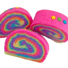 three rainbow colored rolls with stars on the top and one rolled up to look like a spiral