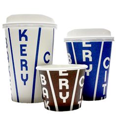 three coffee cups sitting next to each other on top of a white surface with blue letters