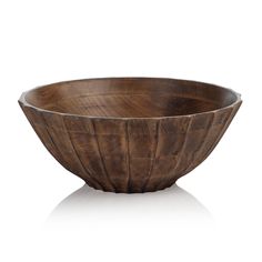 a wooden bowl sitting on top of a white surface