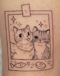 a cat and fish tattoo on the back of a woman's leg, with an image of two cats looking at each other