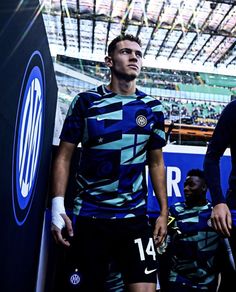 two soccer players standing next to each other