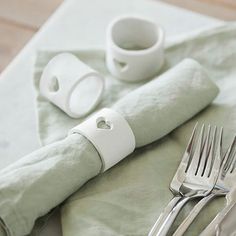 a table with silverware and napkins on it, including a fork and knife