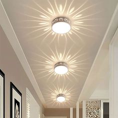 a hallway with white walls and lights on the ceiling