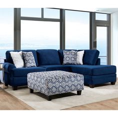 a living room with a blue couch and ottoman