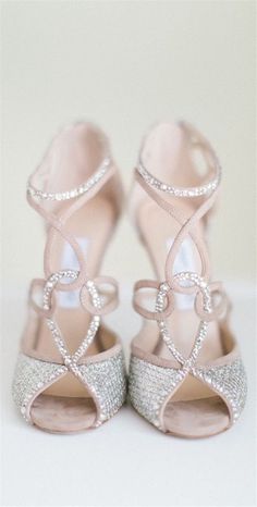 a pair of pink high heeled shoes sitting on top of a white table