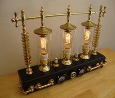 three light bulbs sitting on top of a wooden table next to a lamp bulb holder