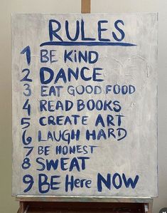 a sign with rules written on it in front of a wall