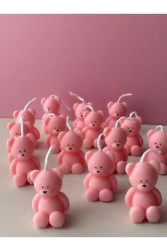 small pink teddy bears with white string attached to them