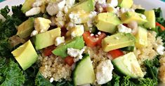 a salad with avocado, tomatoes, feta cheese and lettuce