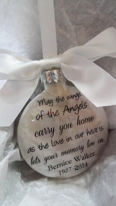 a glass ornament with a poem written on it and a white ribbon tied around it