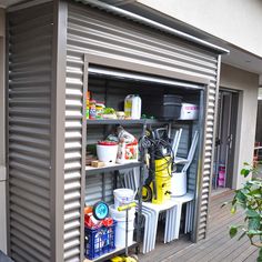 an outdoor storage shed with several items on it