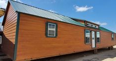 a small wooden house sitting on top of a trailer