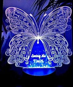 a blue butterfly shaped night light on a table