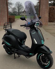 a black scooter parked in front of a building