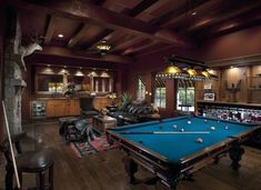 a pool table in the middle of a living room filled with furniture and decor items