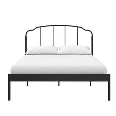 a black metal bed frame with white pillows