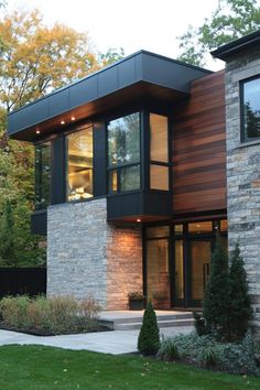 a modern house with stone and wood exterior