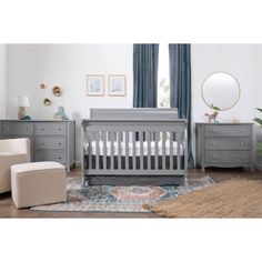 a baby's room with gray furniture and blue curtains