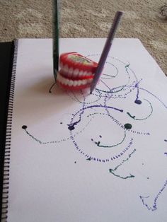 a toothbrush sitting on top of a piece of paper next to a pencil and marker