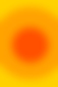 an orange and yellow background with some black dots in the center on top of it