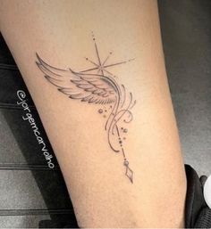 a woman's leg with a tattoo on it and an arrow in the middle