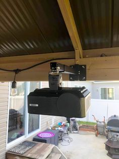 an overhead projector mounted to the side of a house