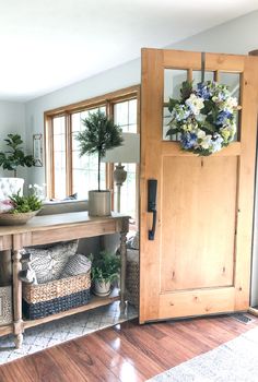 a living room filled with lots of furniture and flowers on top of a wooden table