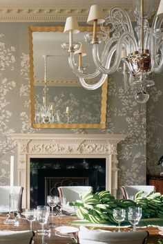 a dining room table with plates and glasses on it