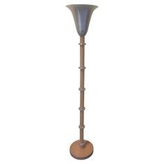 a tall wooden floor lamp on a white background