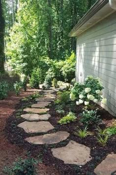 a stone path leading to a house in the woods