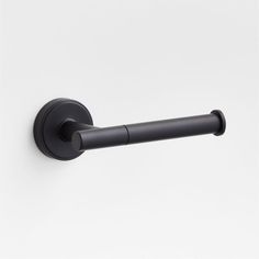 a black toilet roll holder on a white wall