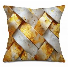 a yellow and white pillow with an abstract design