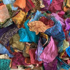 a pile of colorful scarves sitting next to each other