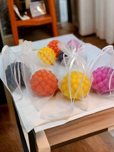 four bags filled with candy sitting on top of a table