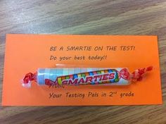 a candy bar on top of an orange card that says be a smartie on the test do your best today