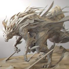 a wooden sculpture of a dragon with long horns and claws on it's back legs