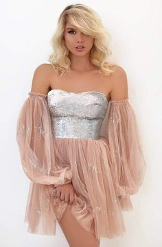 Appeals in a strapless, sweetheart neckline with fitted bodice ornate with sequins. The dress is secured at the back with a zipper closure while and comes with optional off-shoulder tulle sleeves. From the waist flourishes a gathered mid-thigh A-line skirt. Model is wearing Nude color. Pink Hoco Dress, Tarik Ediz Dresses, Tulle Long Dress, Sequin Dress Short, Strapless Dresses Short, Short Dress Styles, Tarik Ediz, Tulle Sleeves