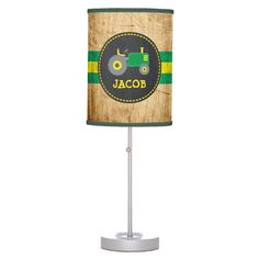 a lamp with a tractor on it and the name jacor written in green