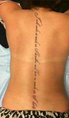 the back of a woman's lower back with an inscription on her left side