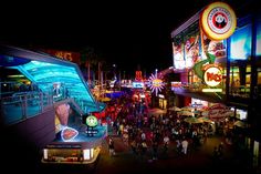 an overhead view of universal citywalk at night with people walking around and on the street