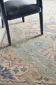 a blue chair sitting on top of a rug