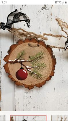 a wooden slice with an apple hanging from it's side on a white wall