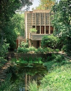 the house is surrounded by trees and water