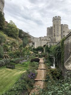 an old castle with lots of trees and bushes